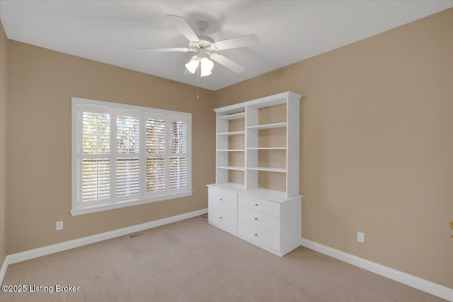 unfurnished bedroom featuring a ceiling fan, carpet flooring, visible vents, and baseboards