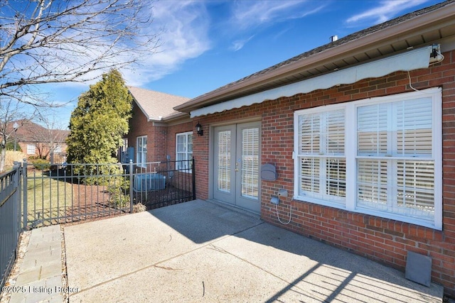 exterior space with french doors and fence