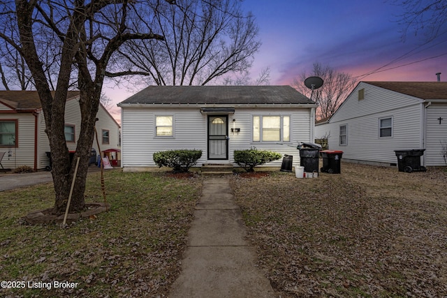 bungalow-style home featuring a lawn