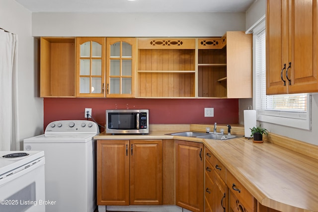 laundry room featuring washer / clothes dryer, plenty of natural light, and sink