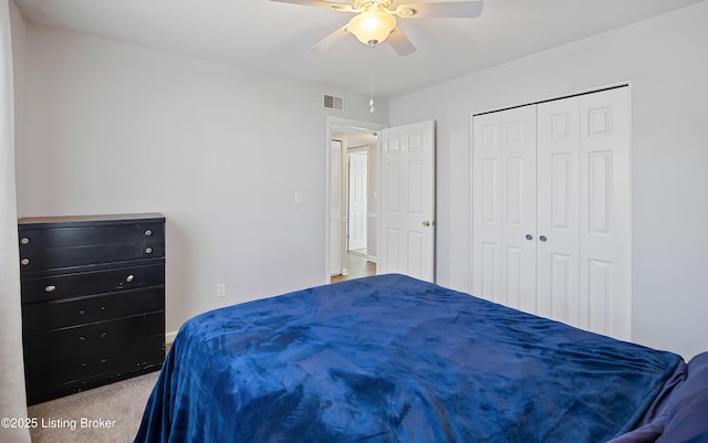 carpeted bedroom with ceiling fan and a closet