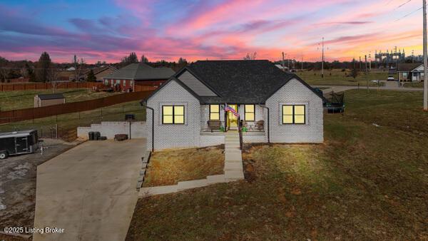 property exterior at dusk with a yard