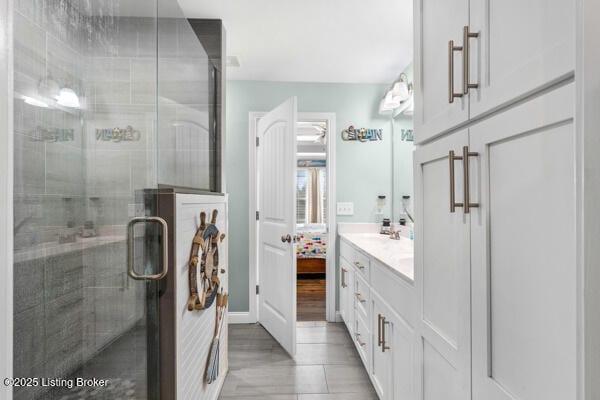 bathroom with vanity, tile patterned flooring, and a shower with door