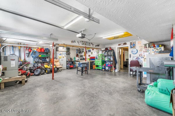 garage with a garage door opener and a workshop area