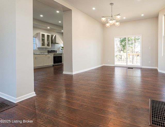 interior space with an inviting chandelier and dark hardwood / wood-style flooring