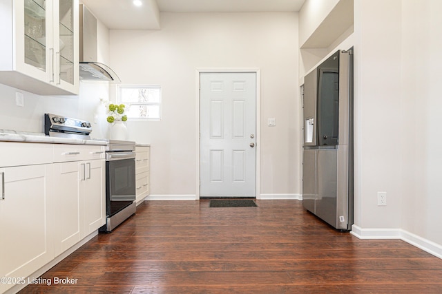 kitchen featuring stainless steel range with electric stovetop, wall chimney range hood, dark hardwood / wood-style floors, and white cabinets