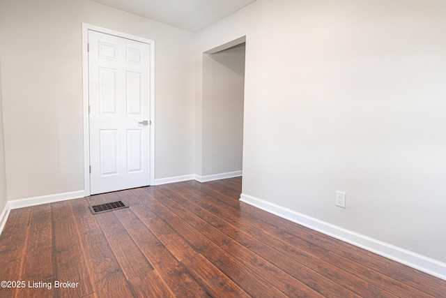 spare room featuring dark hardwood / wood-style flooring