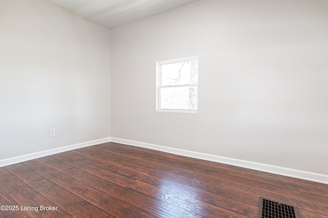 empty room featuring dark wood-type flooring