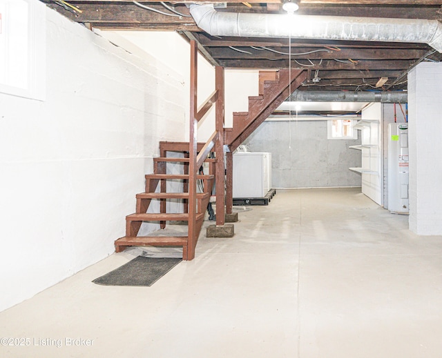 basement with water heater and washer / dryer