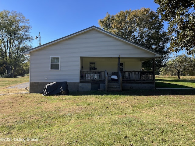 view of side of property with a yard and covered porch