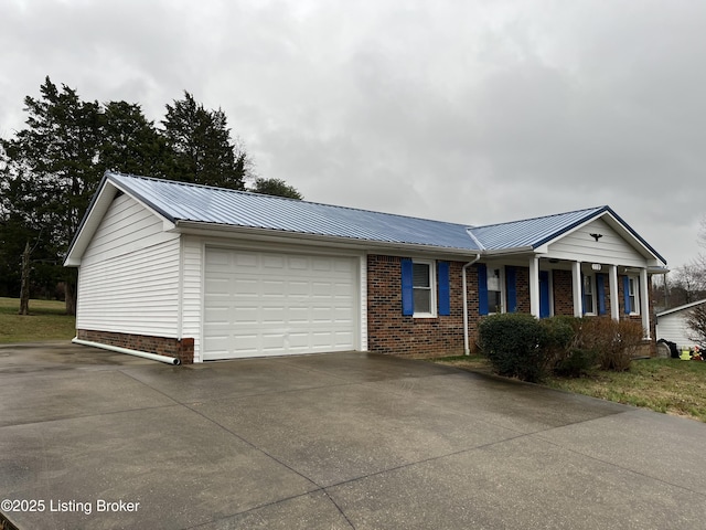 ranch-style house featuring a garage and covered porch