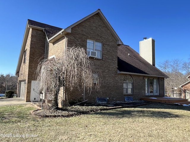 view of home's exterior with cooling unit, a garage, and a lawn