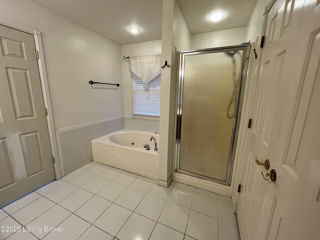 bathroom featuring tile patterned flooring and separate shower and tub