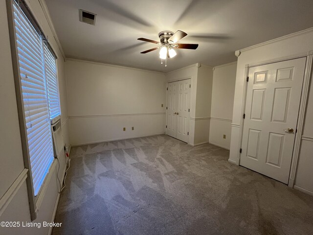 unfurnished bedroom with crown molding, ceiling fan, and light colored carpet