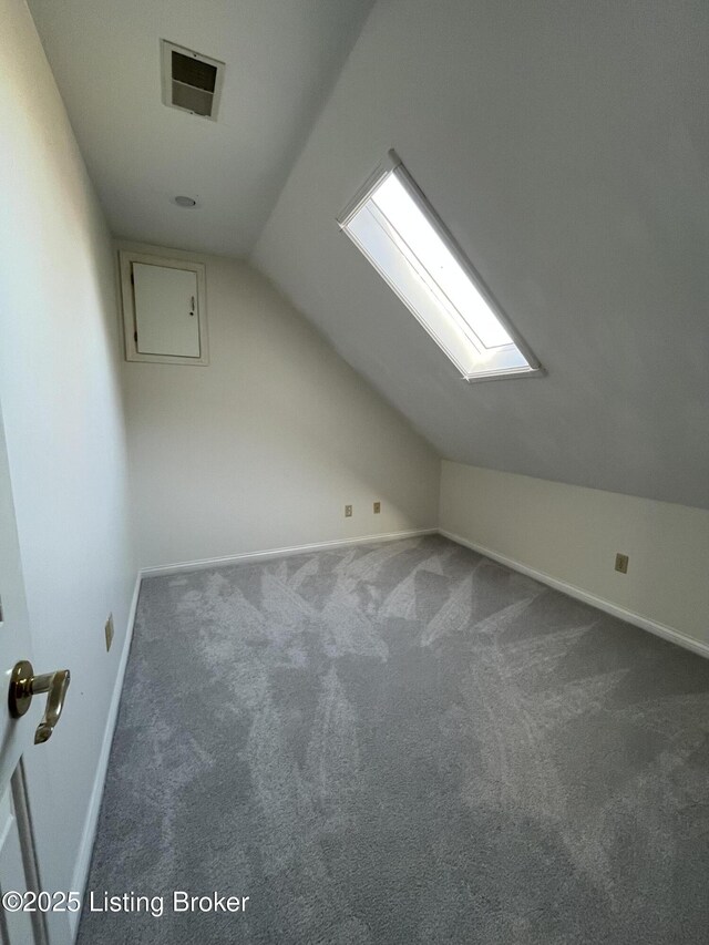 additional living space with lofted ceiling and dark carpet