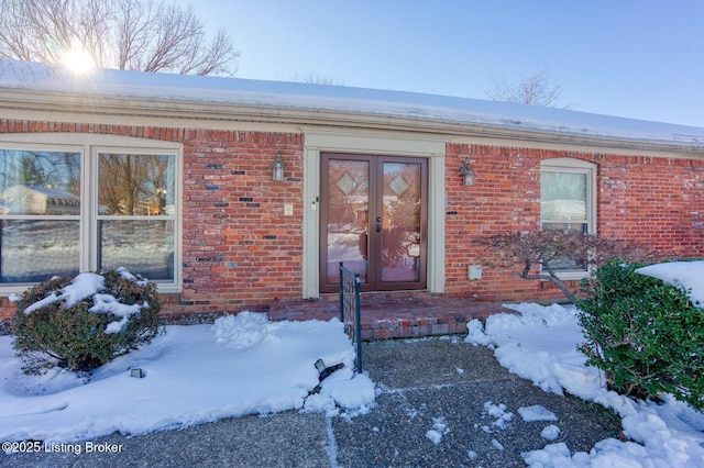 view of snow covered property entrance