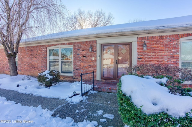 view of snow covered property entrance