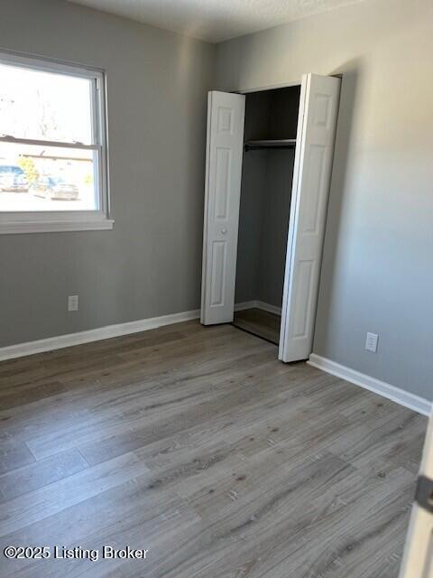 unfurnished bedroom featuring a closet and light hardwood / wood-style flooring