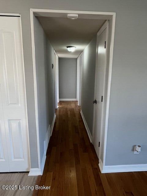 corridor with dark wood-type flooring