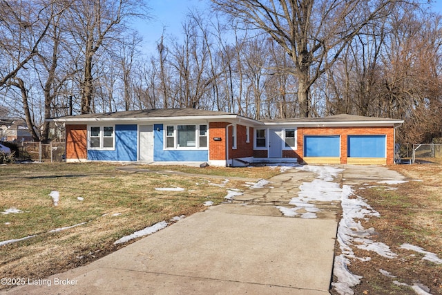 view of front of property featuring a garage and a front lawn