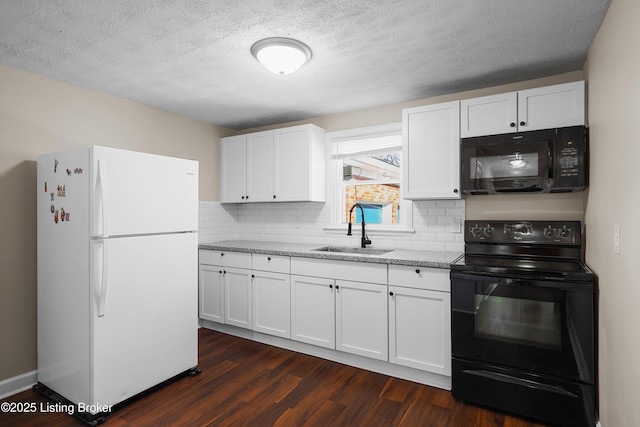 kitchen with sink, dark hardwood / wood-style floors, light stone counters, black appliances, and white cabinets