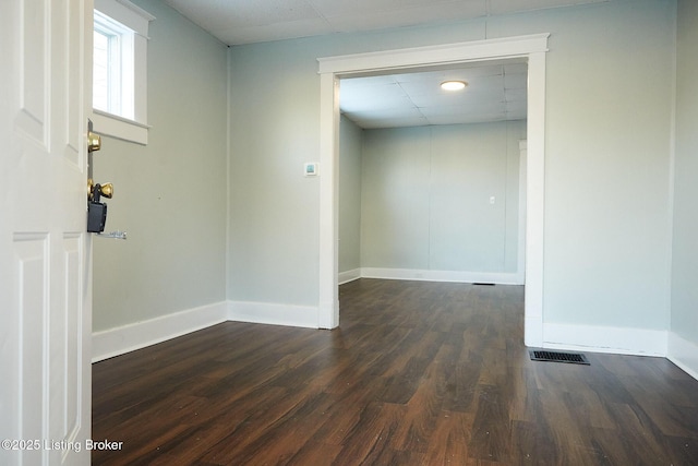 spare room with dark hardwood / wood-style flooring