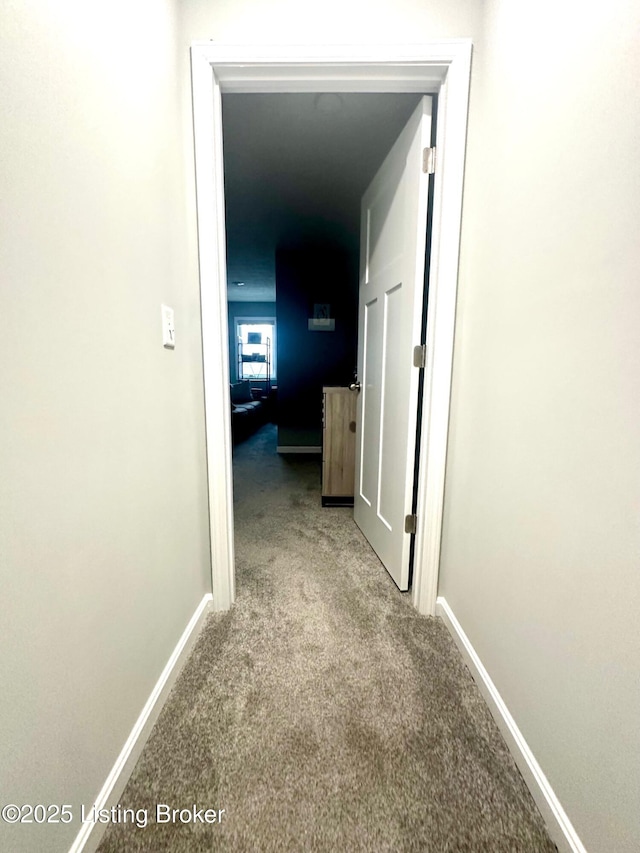 hallway featuring light carpet