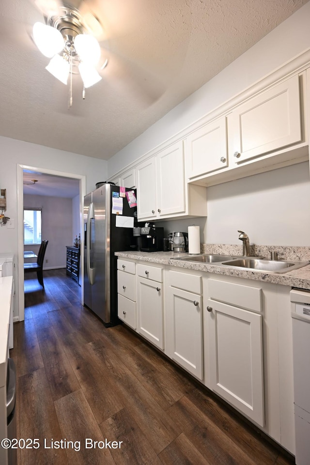 kitchen featuring dark hardwood / wood-style flooring, sink, dishwasher, and white cabinets