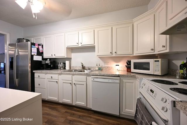 kitchen featuring white appliances, ventilation hood, sink, and white cabinets