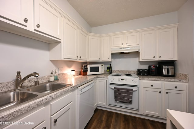 kitchen featuring white cabinetry, sink, white appliances, dark wood-type flooring, and a textured ceiling