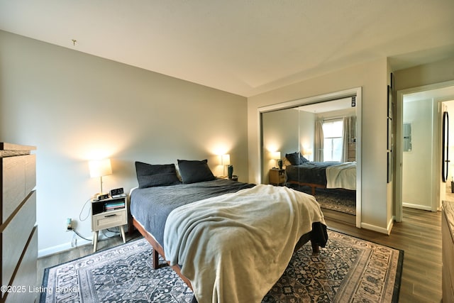 bedroom featuring dark wood-type flooring and a closet