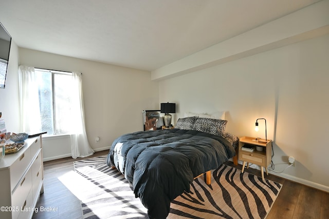 bedroom with dark hardwood / wood-style floors