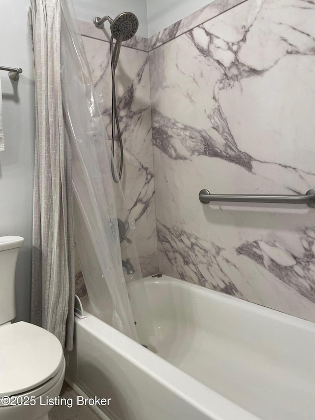 bathroom featuring shower / bath combo and toilet