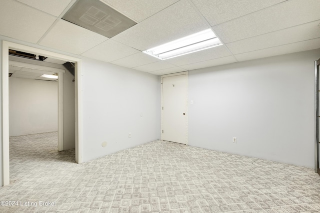 basement with light carpet and a drop ceiling