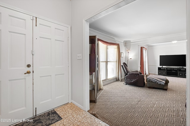 carpeted foyer entrance with ornamental molding