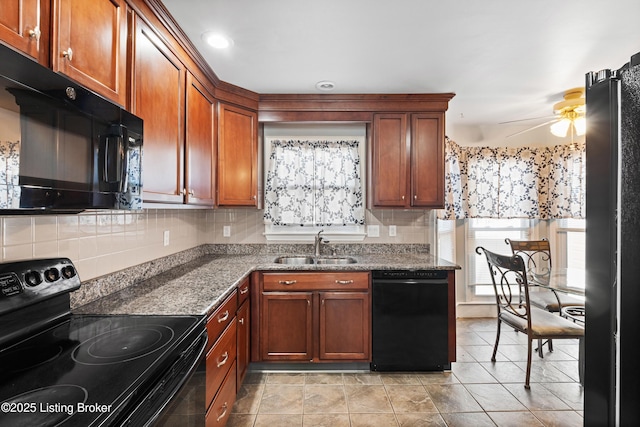 kitchen with sink, black appliances, ceiling fan, and stone countertops