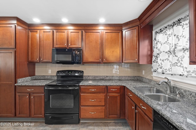 kitchen with tasteful backsplash, sink, black appliances, and stone countertops