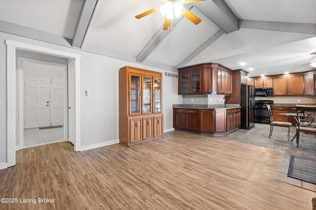 kitchen featuring beamed ceiling, light wood-type flooring, ceiling fan, and black appliances