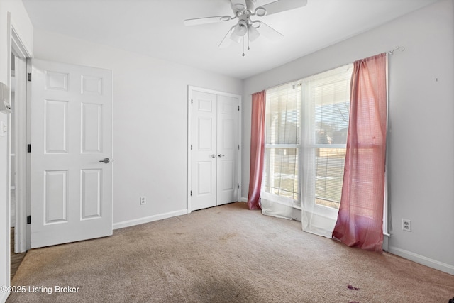 unfurnished bedroom with carpet floors and ceiling fan