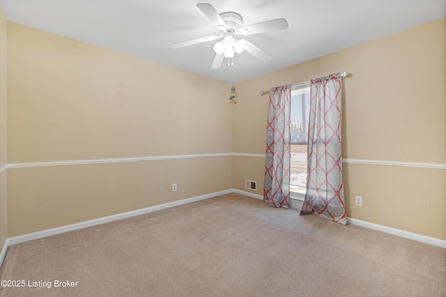 spare room featuring light colored carpet and ceiling fan