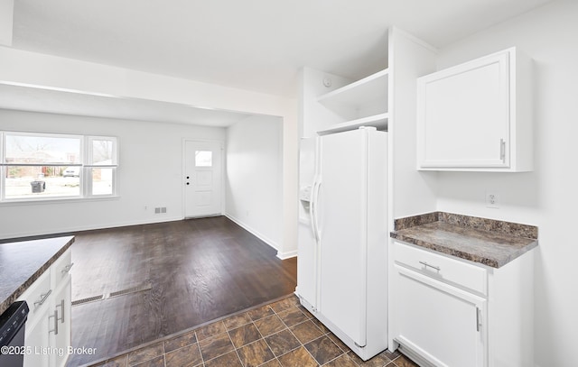 kitchen with dishwasher, white refrigerator with ice dispenser, and white cabinets