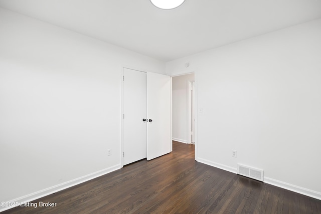 empty room with dark hardwood / wood-style floors