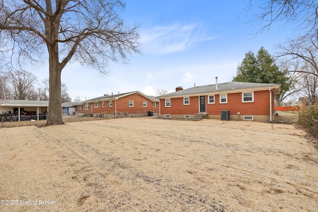 rear view of property with central AC unit