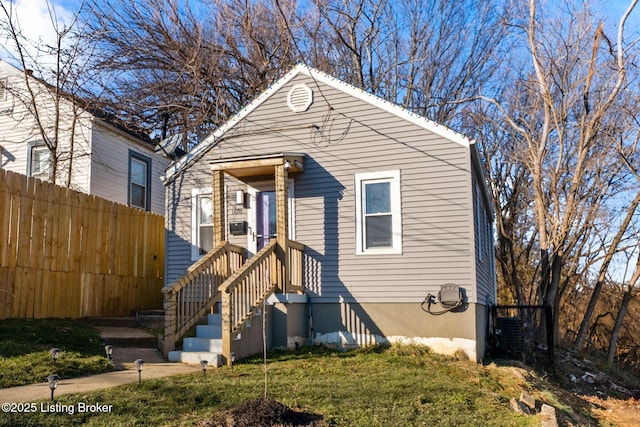 bungalow-style home featuring a front lawn