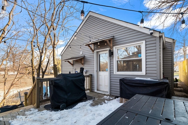 view of snow covered rear of property