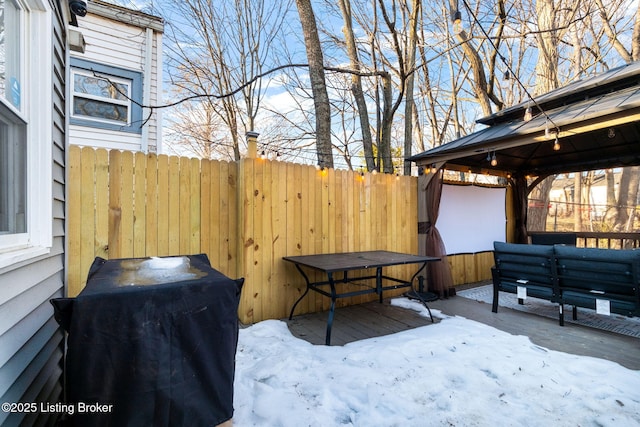 snow covered deck with an outdoor hangout area, a gazebo, and grilling area