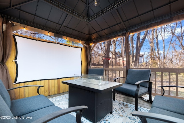 deck featuring a gazebo and an outdoor fire pit