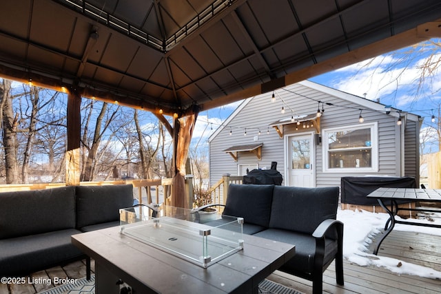 snow covered deck featuring a gazebo and outdoor lounge area