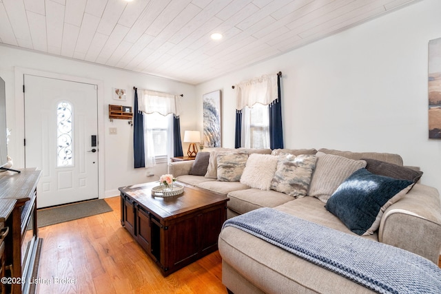 living room featuring light wood-type flooring and wooden ceiling