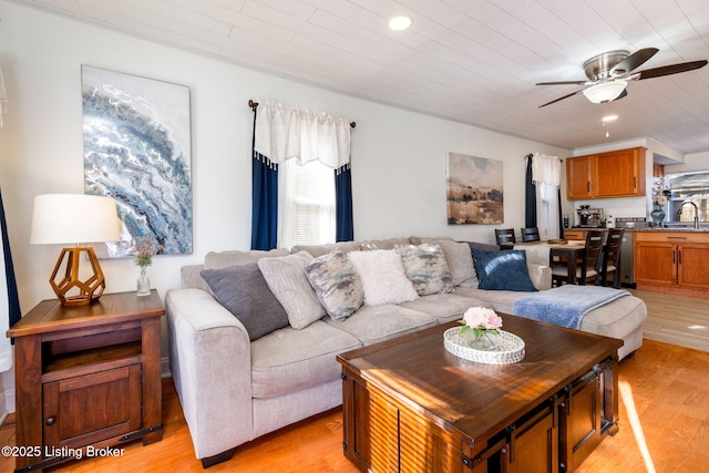 living room with sink, light hardwood / wood-style flooring, wooden ceiling, and ceiling fan